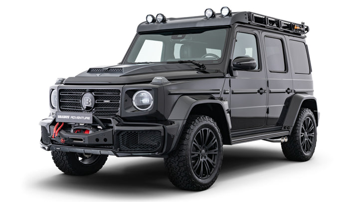BRABUS Adventure Package components: spare wheel holder, roof ladder, LED wind deflector, roof rack, winch, and lift kit for Mercedes G-Class W463A installed on black G-Wagon, front right side view of the SUV