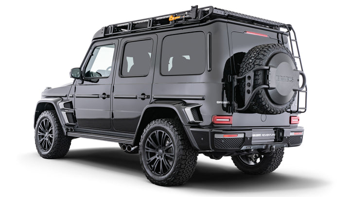 BRABUS Adventure Package for Mercedes G-Class W463A, featuring carbon fiber options, roof rack, LED wind deflector, rope winch, and lift kit. right rear view showing spare wheel holder