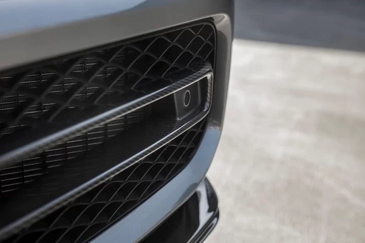 Urban Automotive carbon fiber intake trims mounted on Mercedes-AMG G63 front bumper, enhancing aggressive styling.