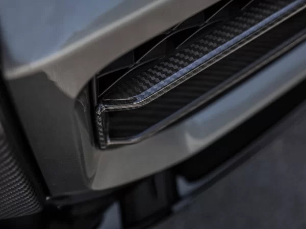 Urban Automotive carbon fiber intake trims mounted on Mercedes-AMG G63 front bumper, enhancing aggressive styling.