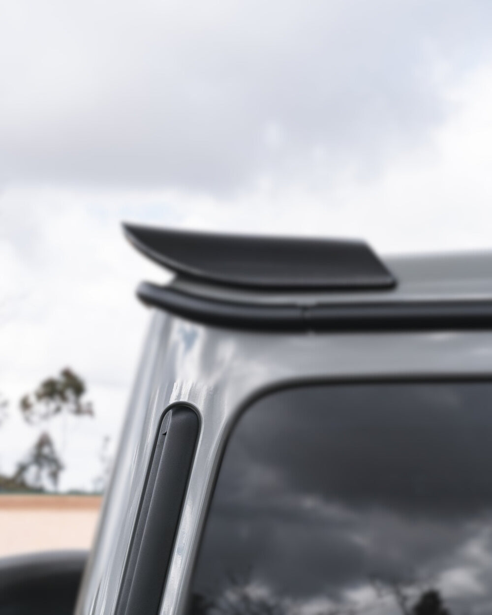 Textured carbon fiber surface of Urban Automotive C-pillar trim for Mercedes-AMG G63 (2019+).