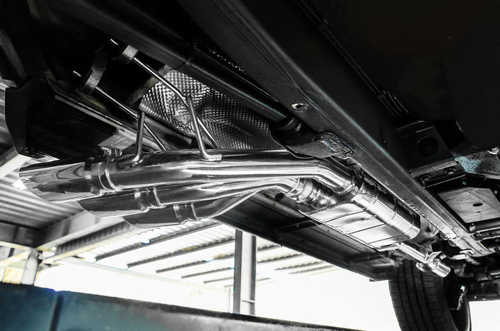 OEM-style fitment of iPE performance exhaust on Mercedes G500 4×4²" photo showing system install from underneath 