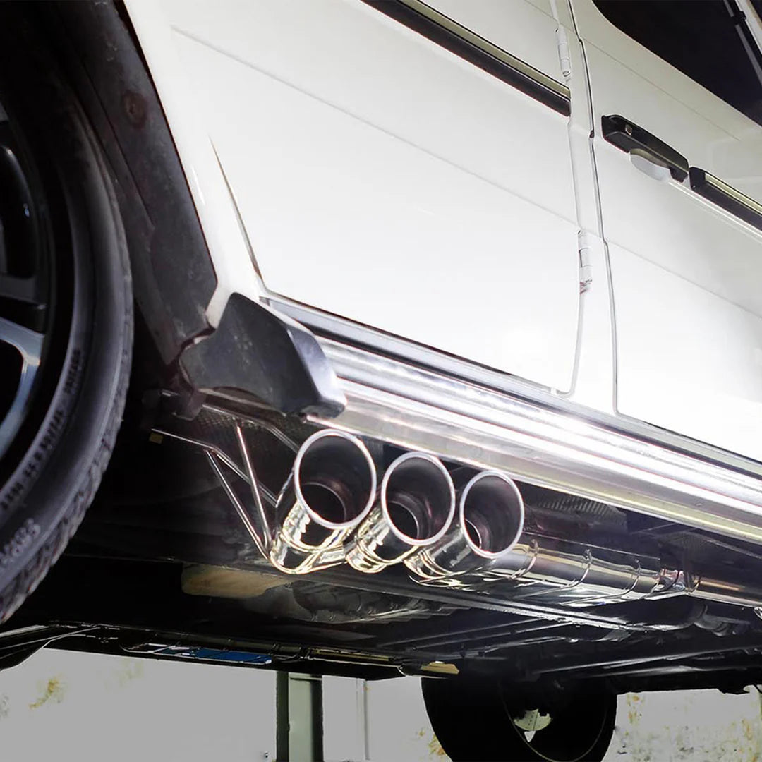 Ipe exhaust system installed on white G-wagon. close up showing exhaust tips from a side exit 