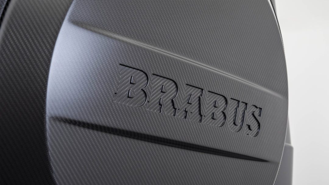 Carbon fiber spare tire cover in the style of Brabus, designed for Mercedes-Benz G-Class models, featuring a sleek and durable carbon fiber construction