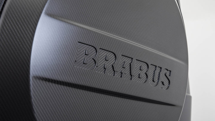 Carbon fiber spare tire cover in the style of Brabus, designed for Mercedes-Benz G-Class models, featuring a sleek and durable carbon fiber construction