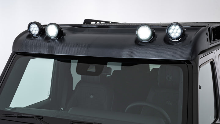 BRABUS Adventure Wind Deflector with LED lights, crafted from durable carbon fiber to withstand windy weather, compatible with roof rack upgrades.