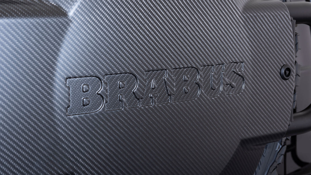 Luxury BRABUS Carbon Fiber Spare Wheel Holder with powder-coated steel construction, designed for durability and style on G-Class models. close up shot showing brabus embossed logo 