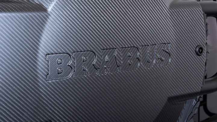 Luxury BRABUS Carbon Fiber Spare Wheel Holder with powder-coated steel construction, designed for durability and style on G-Class models. close up shot showing brabus embossed logo 