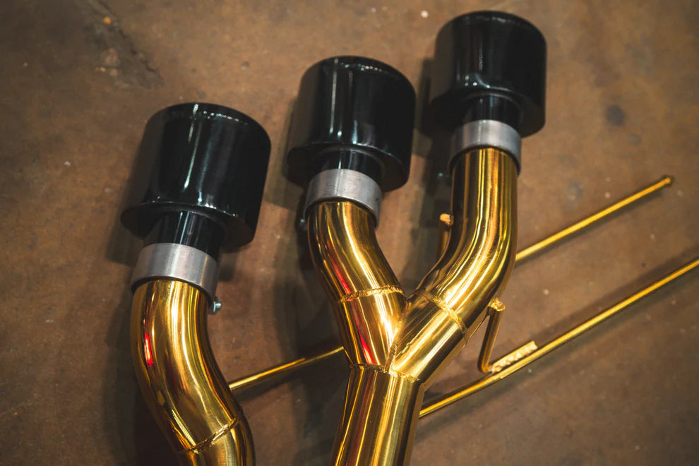 Close-up of Valvetronic exhaust's black ceramic tips with laser-etched branding on Mercedes G-Wagon