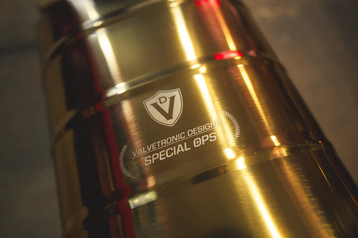 Close-up of Valvetronic exhaust's black ceramic tips with laser-etched branding on Mercedes G-Wagon