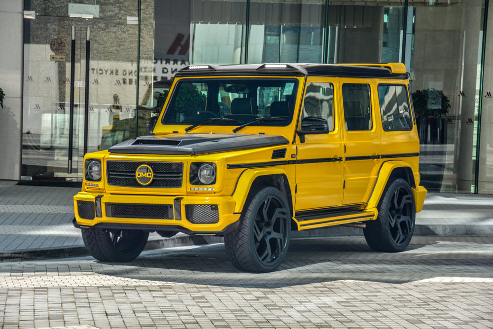 yellow g wagon with DMC Visible Carbon weave pattern on G-Wagon front lip installed, parked in the street