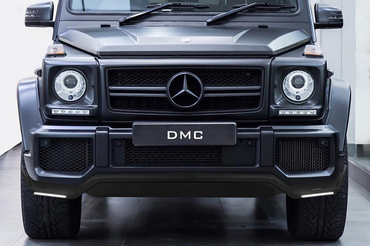 front view of DMC Carbon Fiber LED Front Lip installed on Mercedes-AMG G63 W463 install on a black G-Wagon