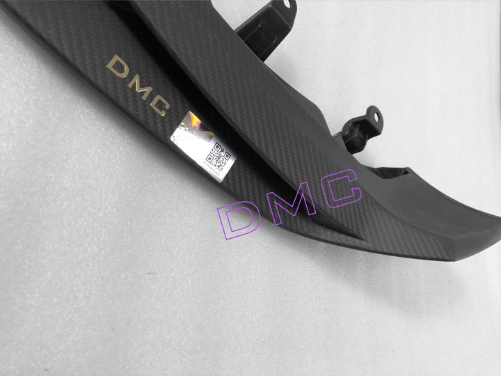 Close-up of DMC's pre-peg dry carbon fiber weave on Mercedes G63 front lip - OEM-grade lightweight construction