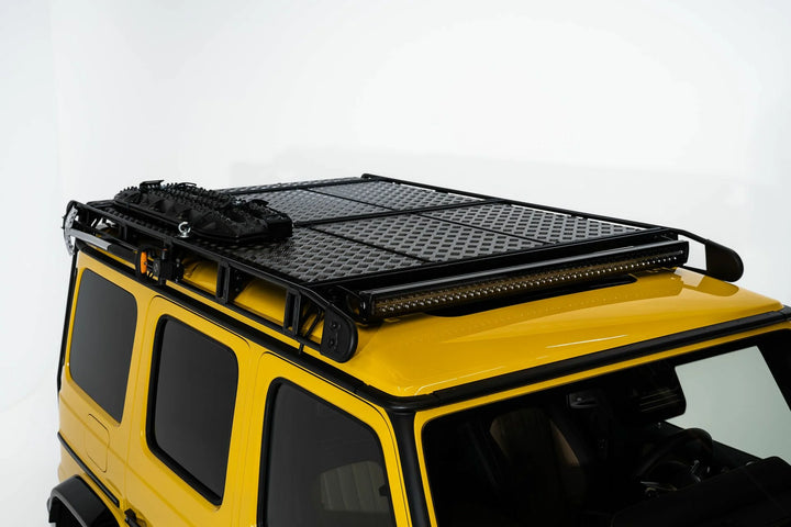 The stylish and functional LETECH Shovel Holder Quickmount for secure tool transport installed onto roof rack on a yellow g-wagon
