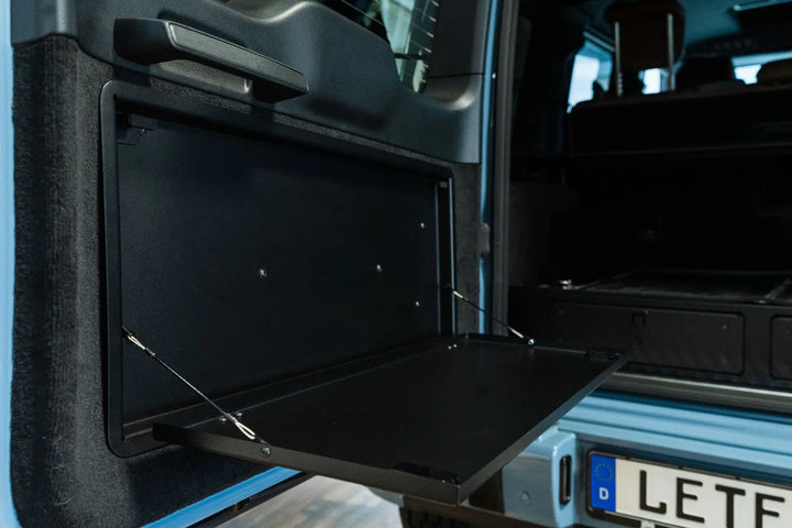 Premium LETECH aluminum folding table attached to the rear door of a G-Class, creating a functional workspace