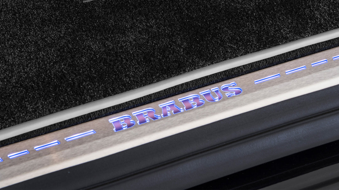 BRABUS Tailgate Entrance Panels installed on a Mercedes-Benz G-Class showcasing RGB-LED illuminated logo.
