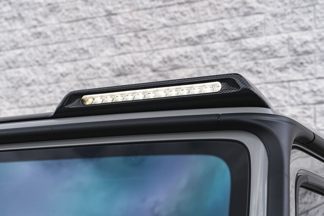Close-up of Urban Automotive carbon fiber LED pod lights - four 4-inch spotlights with 12,000-lumen output for Mercedes G-Class