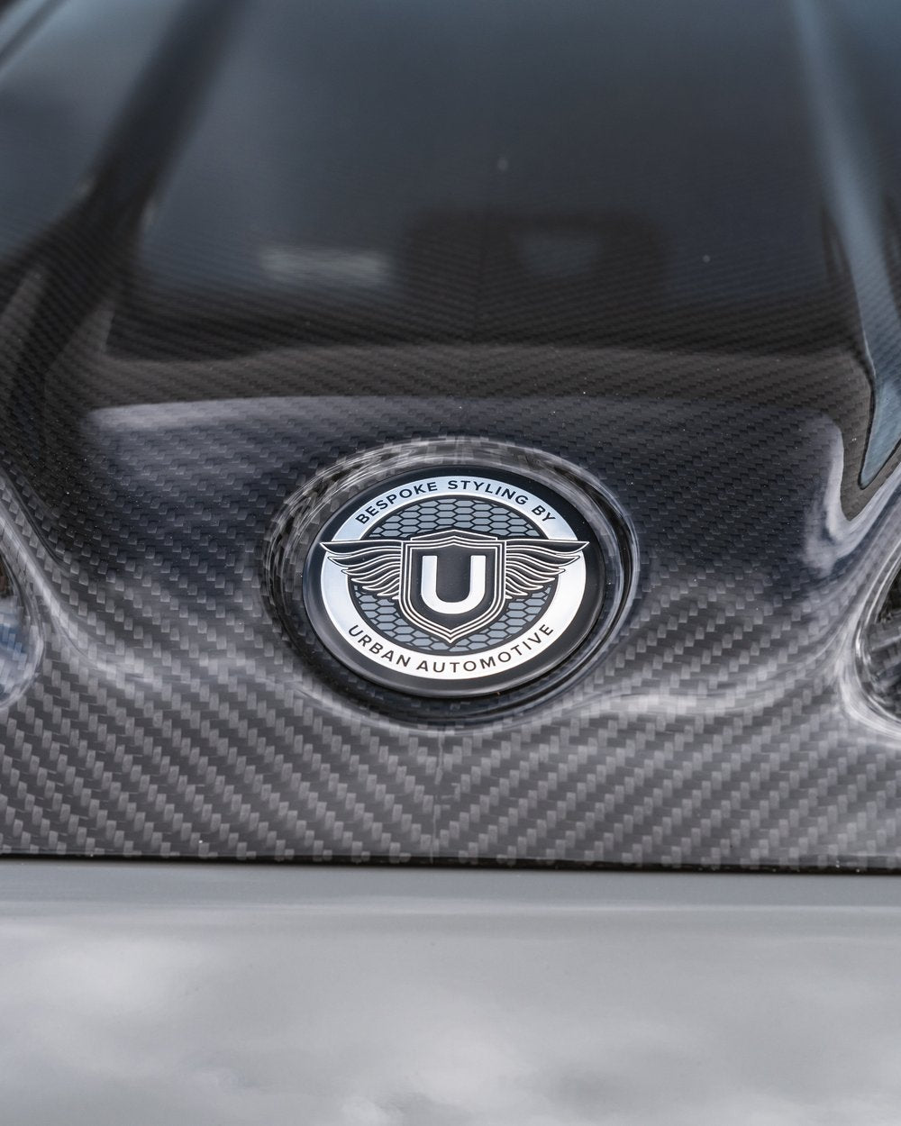 Precision 'URBAN' embossing on carbon fiber G-Wagon bullnose hood with functional vents.