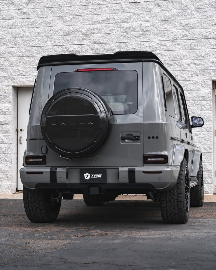 Urban Automotive carbon fiber wheel cover installed on Mercedes G-Class W463A rear wheel, showcasing seamless fit.