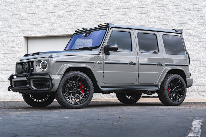 Urban Automotive carbon fiber hood mounted on Mercedes-AMG G63, enhancing performance cooling and aggressive styling."