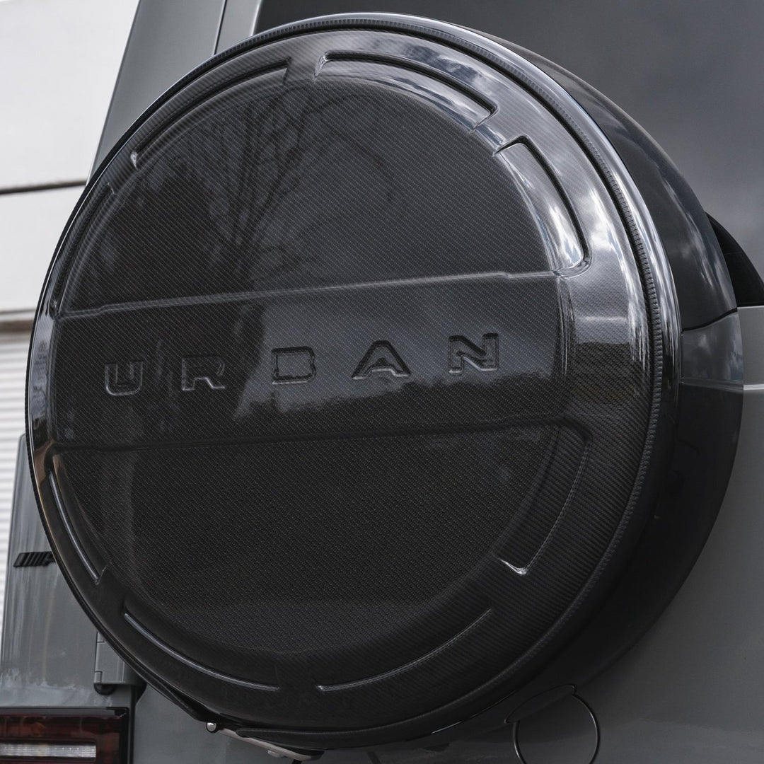 Close-up of premium carbon fiber weave on Urban Automotive rear wheel cover for G-Class W463A.