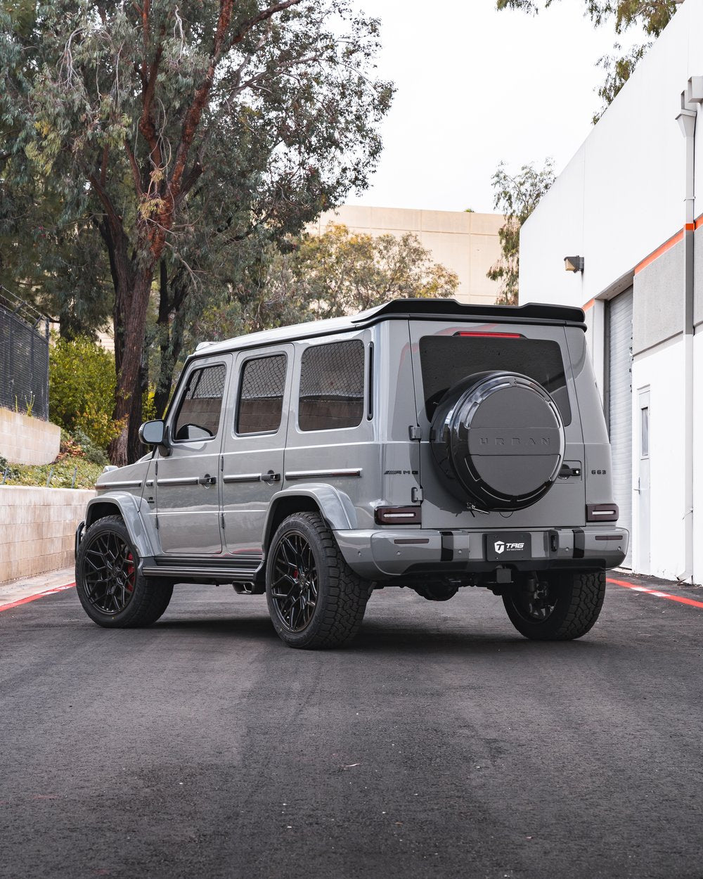 Urban Automotive carbon fiber rear spoiler mounted on Mercedes-AMG G63, enhancing aggressive rear styling.