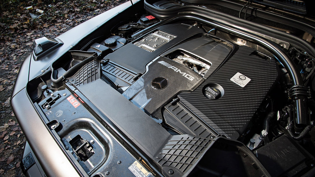 birds eye view of DMC's carbon fiber engine cover— installed on a grey G-wagon. 