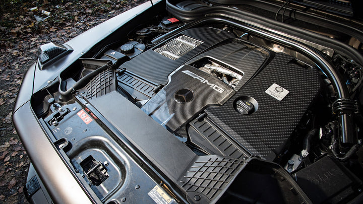 birds eye view of DMC's carbon fiber engine cover— installed on a grey G-wagon. 