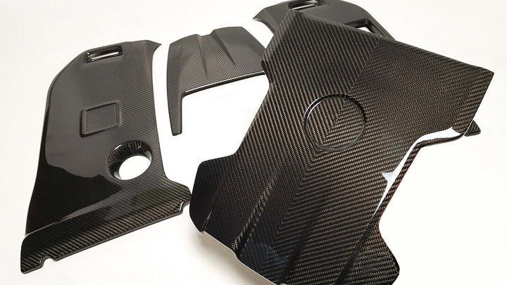 DMC carbon fiber engine cover for Mercedes-AMG G63 (2019-2025) - glossy finish with visible weave pattern apart on a white background 