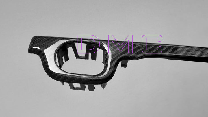 Handcrafted forged carbon fiber weave on DMC dashboard trim for G63 AMG - lightweight TUV-certified material close up shot on the left side of the product