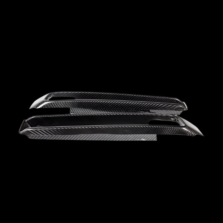 Urban Automotive carbon fiber bumper intake trims for Mercedes G-Class W463A, featuring high-gloss forged carbon weave and precision OEM fitment (2019+).