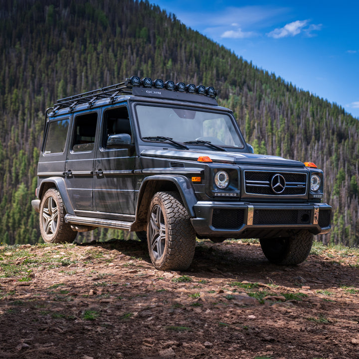 GOBI Stealth Rack installed on Mercedes G-Wagon (no sunroof), showcasing low-profile design and integrated lightbar mounts front right view of g wagon in the forest 