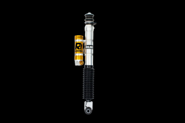 Close-up of RENNtech adjustable suspension shocks, highlighting external reservoirs and premium construction for G-Wagon.