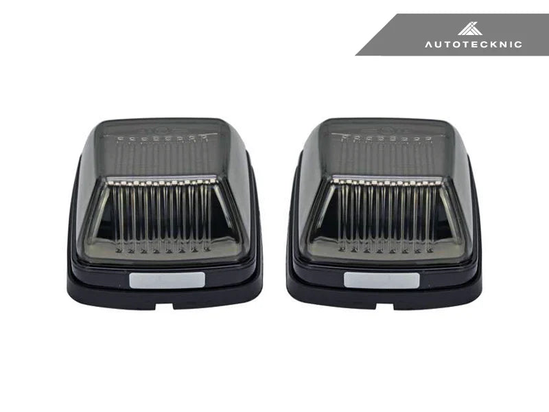 Close-up of AutoTecknic smoked lens housing for G-Class turn signals - modern blackout finish complements carbon fiber mirror caps