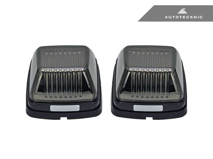 Close-up of AutoTecknic smoked lens housing for G-Class turn signals - modern blackout finish complements carbon fiber mirror caps