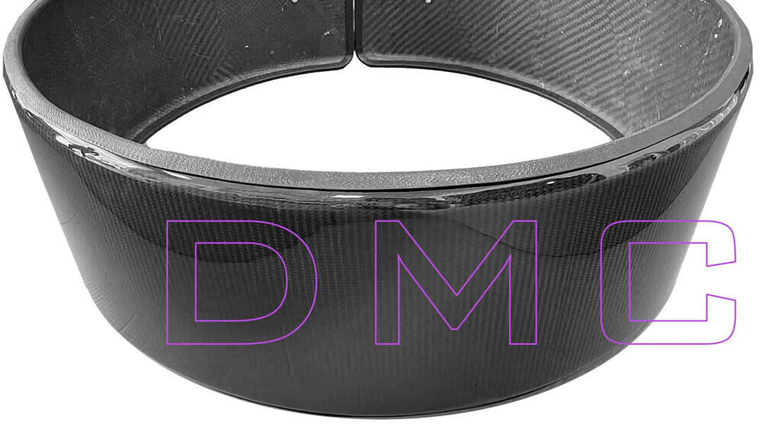 Close-up of DMC carbon fiber spare wheel ring showing autoclave-cured pre-preg construction and UV-resistant clear coat