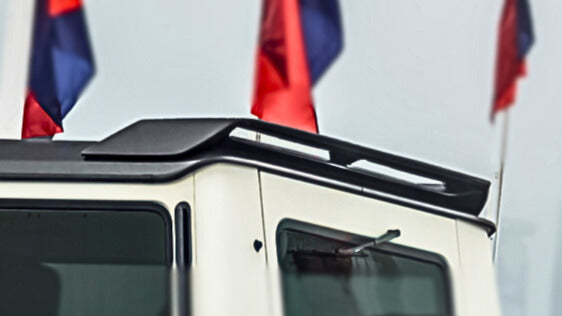 Close-up of DMC's dry carbon fiber weave on G63 roof wing - pre-preg motorsport quality