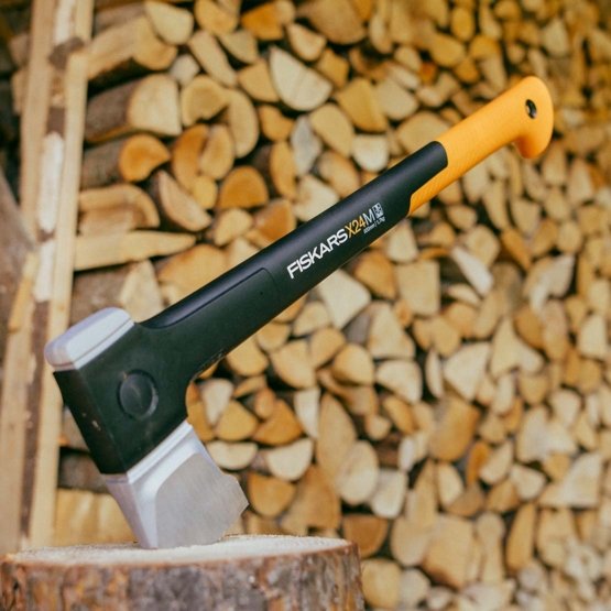Fiskars X24 Splitting Axe in action, demonstrating its ability to split medium-sized logs with ease and precision.