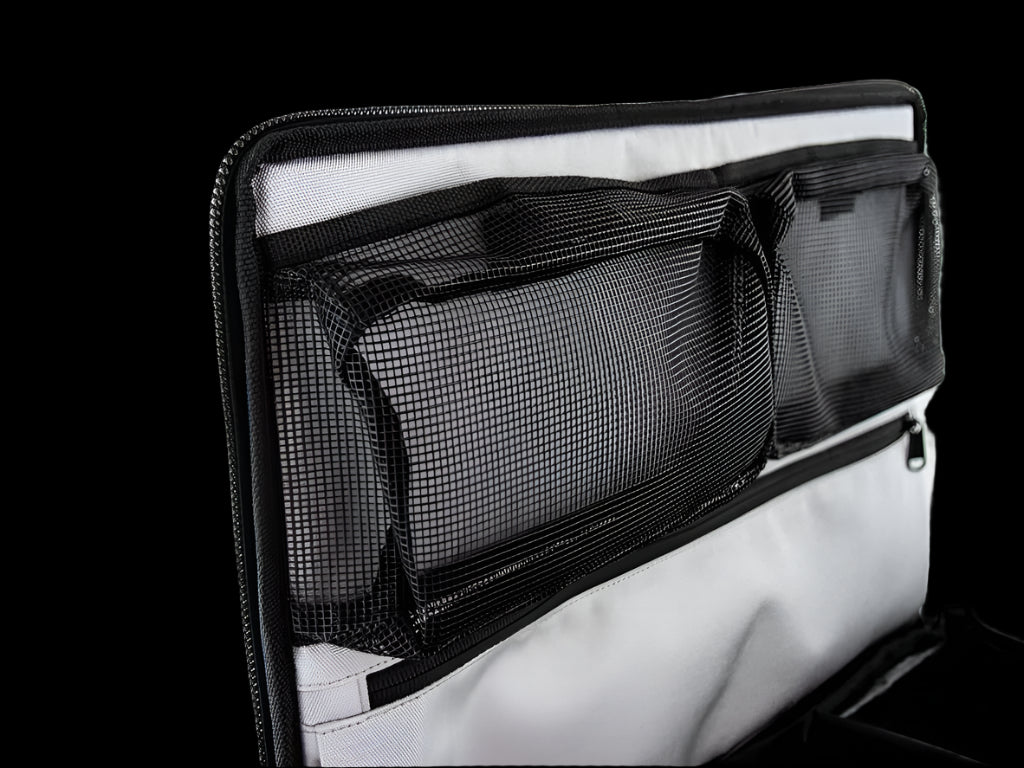 Interior of Front Runner Flat Pack, featuring moveable divider and clear vinyl label pocket for organized packing