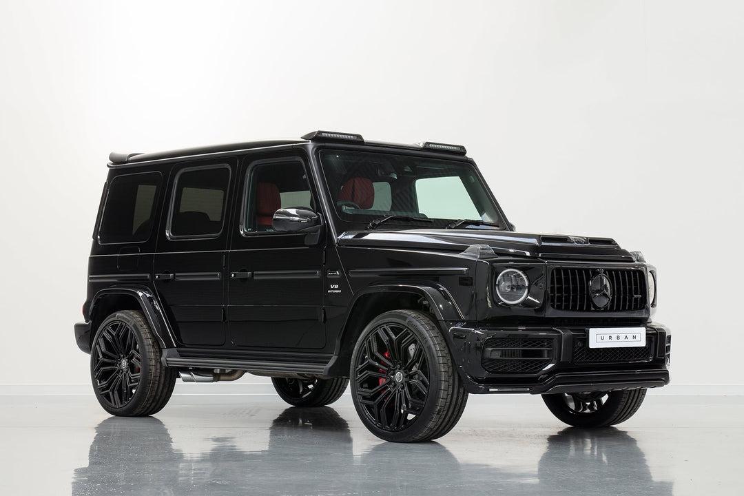Urban Automotive Soft Kit installed on Mercedes-Benz G63 AMG W463A featuring visual carbon fiber hood and roof light cluster