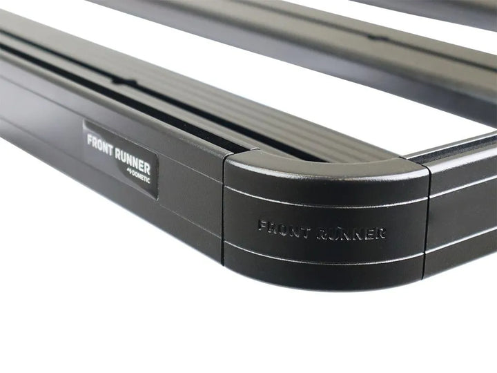 Detail of the black epoxy powder-coated T6 aluminum tray and high-strength steel foot rails, emphasizing corrosion resistance and premium finish.