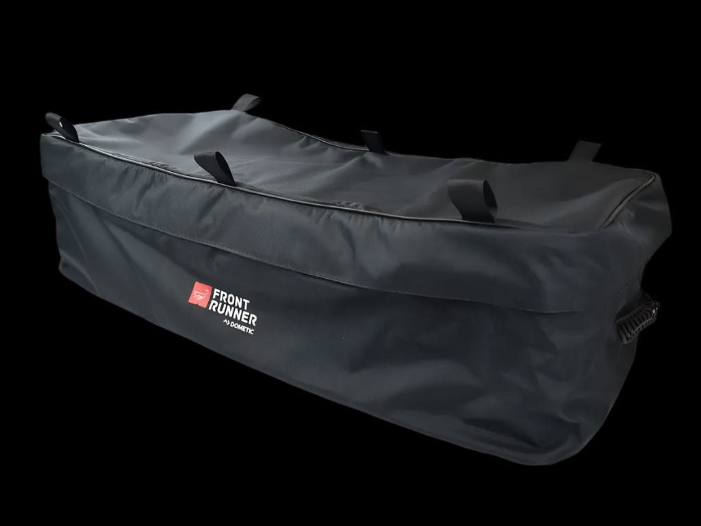 Front Runner Transit Bag Large secured to a roof rack, holding Wolf Pack Pro storage boxes for an organized overlanding setup.