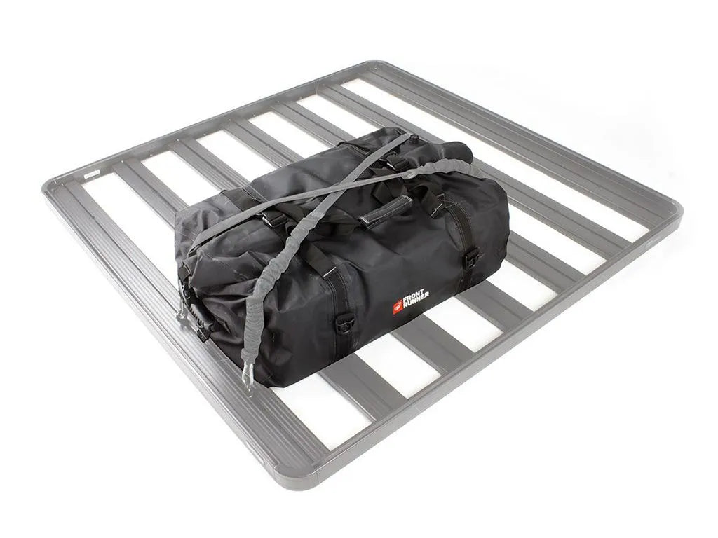 Front Runner Typhoon Bag mounted on a roof rack, showcasing its 100% waterproof and dustproof roll-top design.