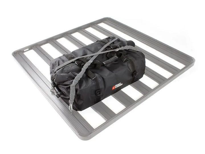 Front Runner Typhoon Bag mounted on a roof rack, showcasing its 100% waterproof and dustproof roll-top design.