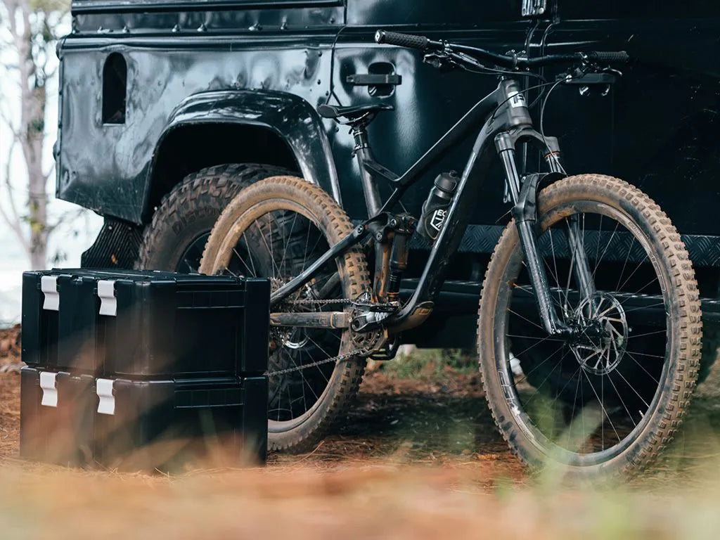 Overlanding setup featuring Front Runner Wolf Pack Pro containers secured on a Slimline II roof rack.