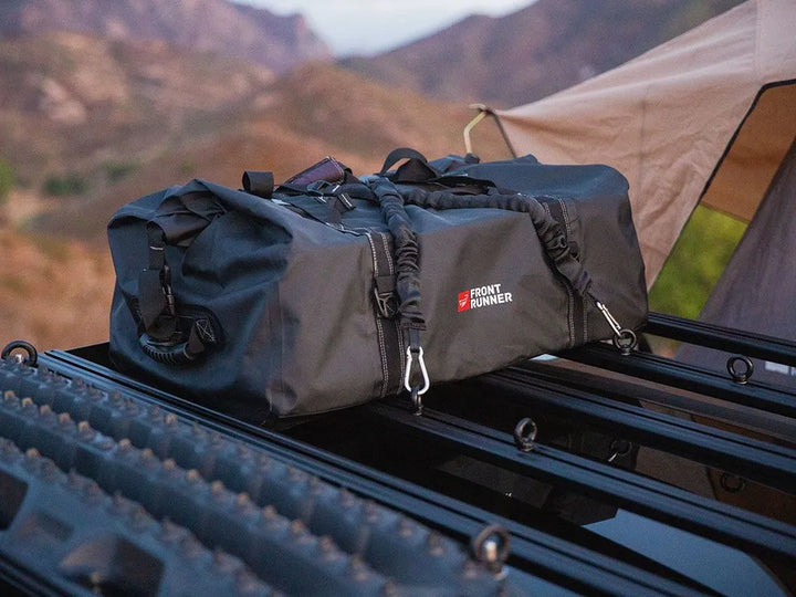 Pair of Front Runner Stratchits stretched across a vehicle roof rack, demonstrating adjustable tie-down length for outdoor gear