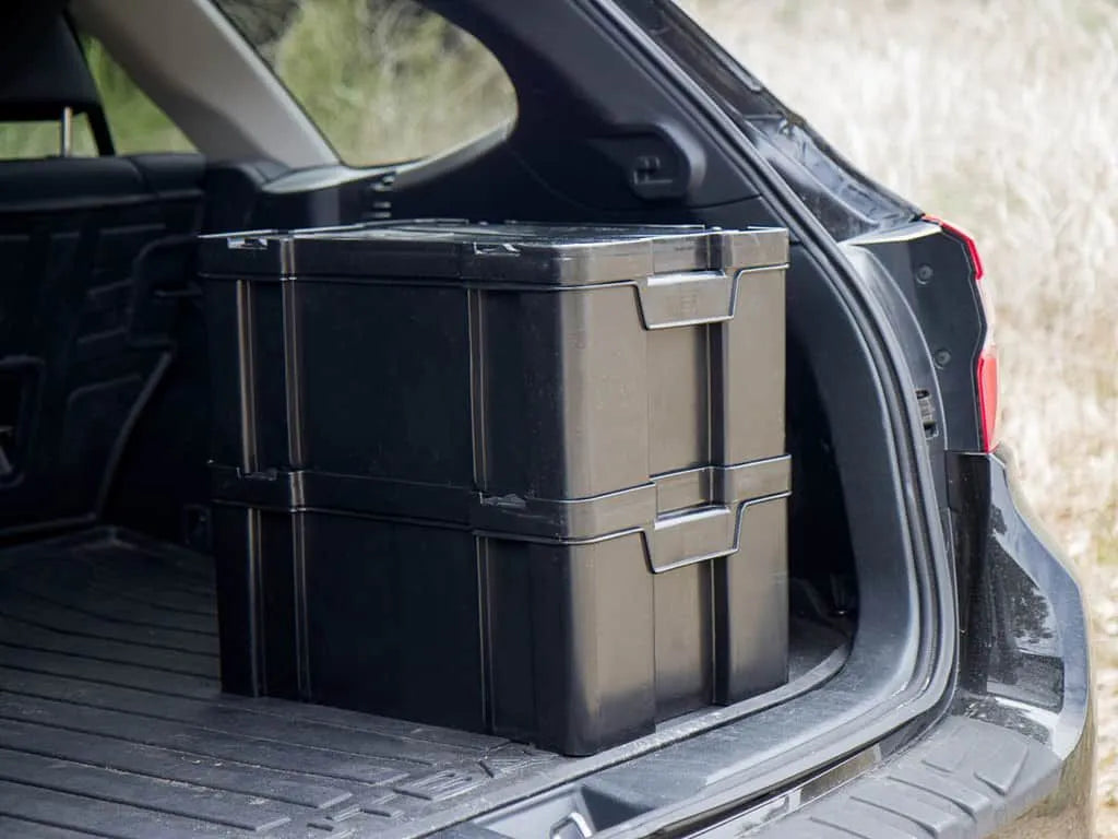 Front Runner Cub Pack stackable storage boxes arranged in a vehicle cargo area for efficient adventure organization.