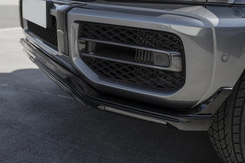 Urban Automotive carbon fiber intake trims mounted on Mercedes-AMG G63 front bumper, enhancing aggressive styling.